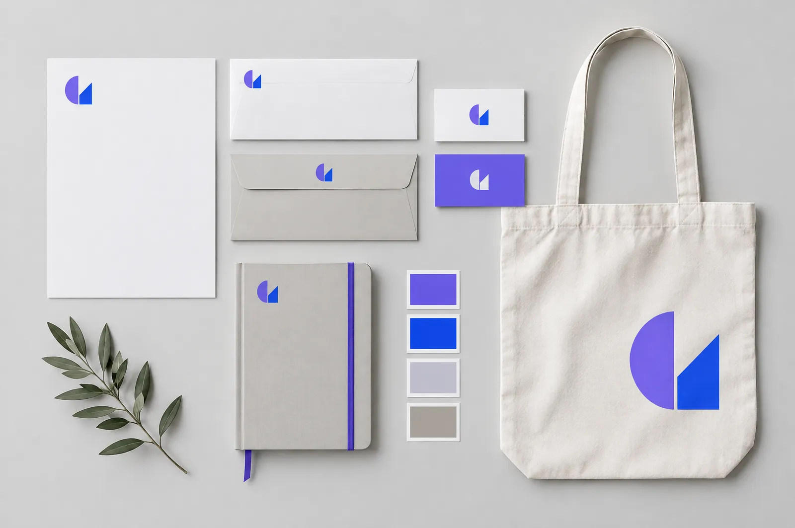 Designer sketching on a tablet beside a printed illustration and icon book
