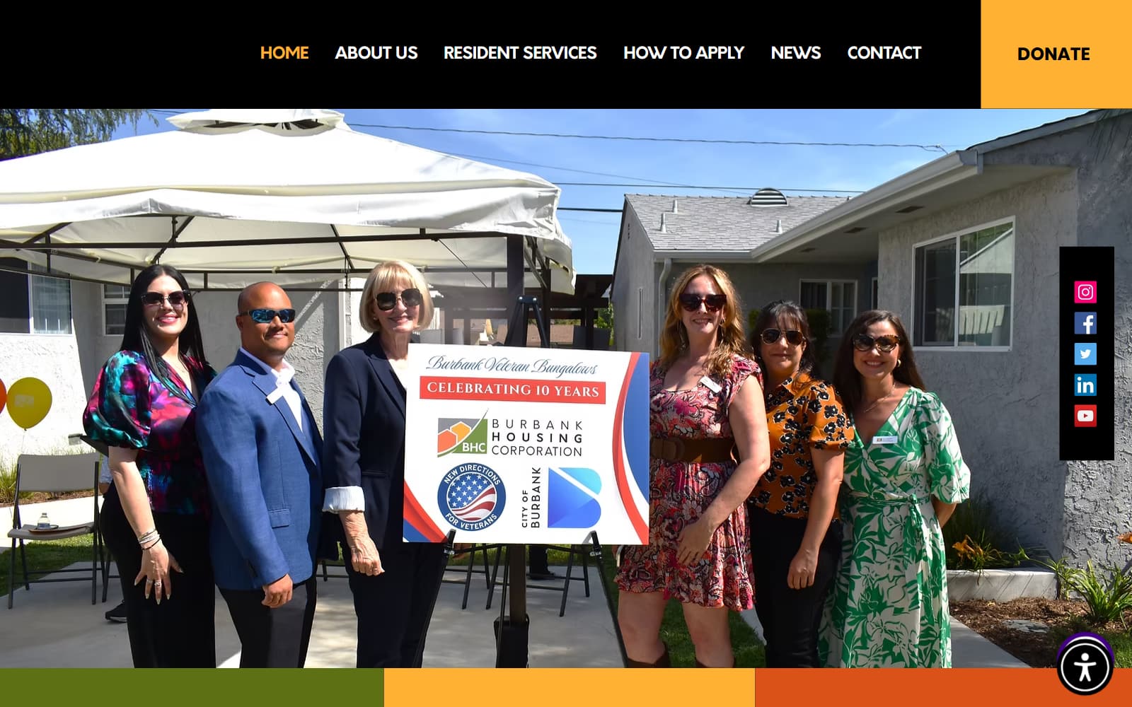 Burbank Housing Corporation homepage with the main navigation, a Donate button and a photo of a group gathered around a “Celebrating 10 Years” sign